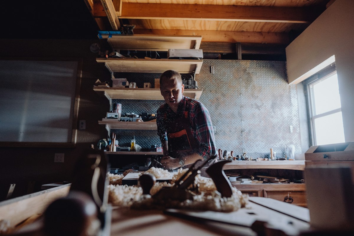 Woodworker at a workshop bench — illustrative photograph